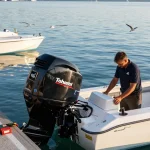 Tohatsu outboard for sale showcased in a coastal marina with a technician performing maintenance.